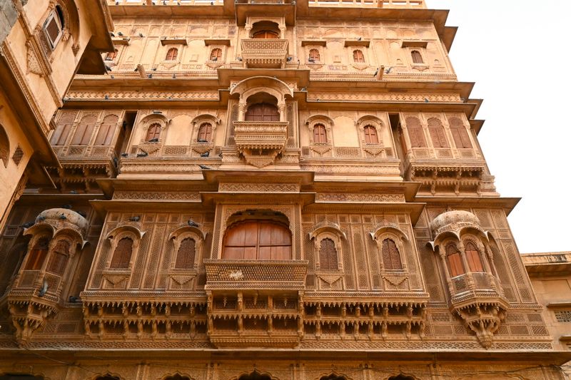 Historic architecture of Patwon ki Haveli in Jaisalmer, showcasing intricate sandstone carvings, adorned with traditional Rajasthani jharokhas, Jaisalmer blog by The Kid Who Travelled.