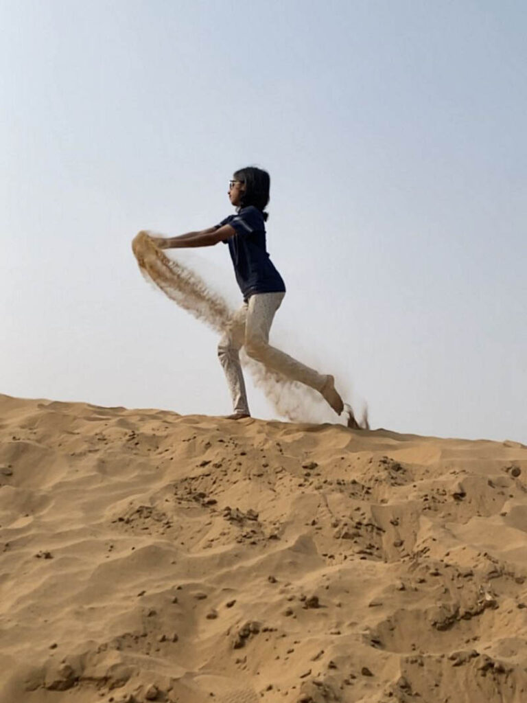 The Kid Who Travelled is playing in sand at the Sand dunes in Jaisalmer Rajasthan, Jaisalmer Blog