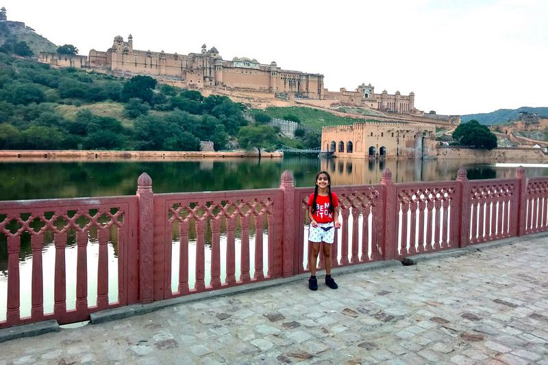 Majestic Amer Fort standing tall on a hilltop, overlooking the Maota Lake in Jaipur, Rajasthan blog by The Kid Who Travelled.