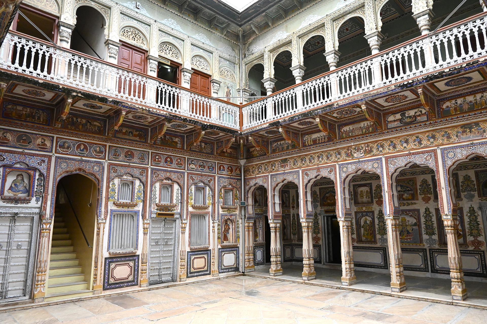 Central courtyard of a well-preserved haveli in Shekhawati, surrounded by beautiful frescos.