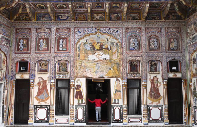 The Kid Who Travelled exploring the interior of Poddar Haveli, admiring its intricate artwork and frescoes depicting mythological scenes in Shekhawati region, Rajasthan